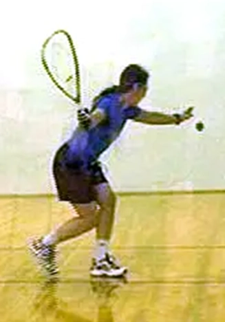 experience-with-feldenkrais Laura Yedwab, a Kirkland Feldenkrais practitioner, serving the ball during a racquetball game on an indoor court.