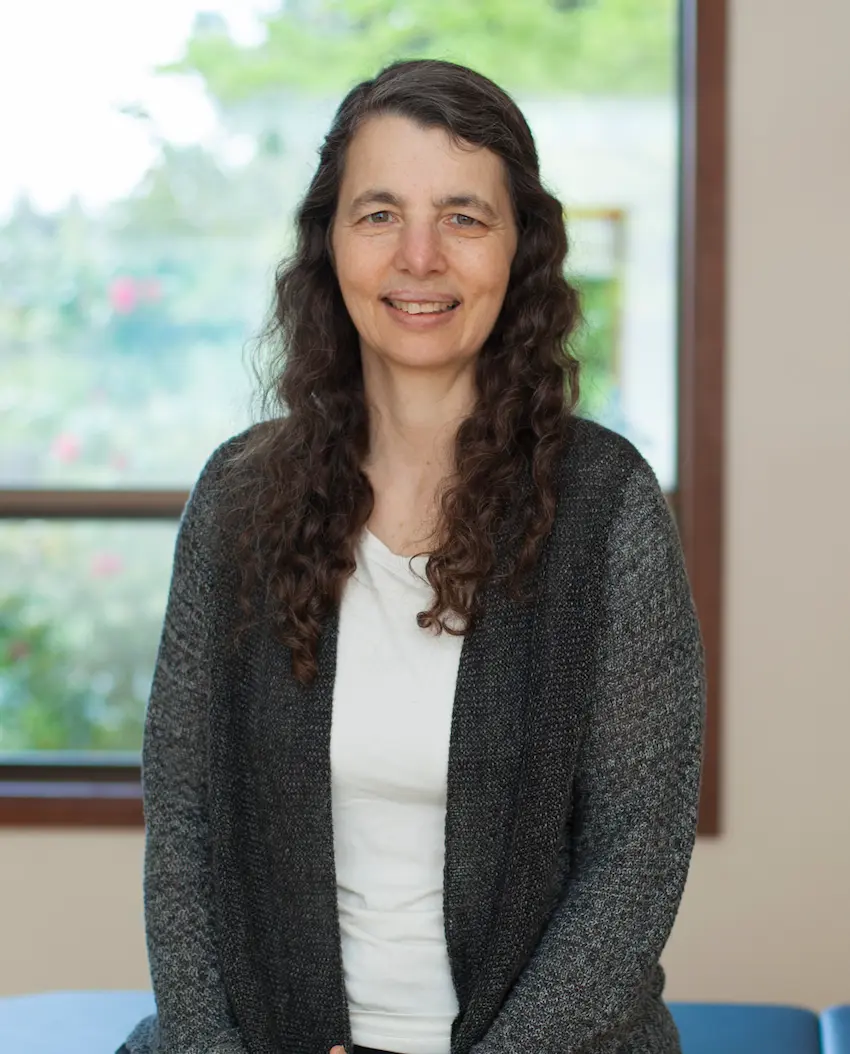 Laura Yedwab, Guild Certified Feldenkrais Practitioner, seated in her Kirkland studio